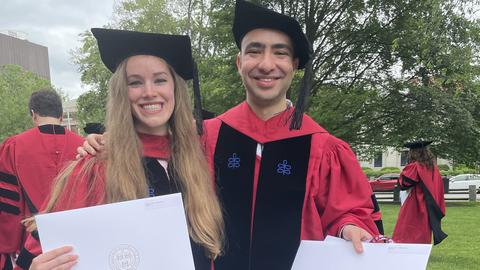 Jennifer and Ahmed with their diplomas at the hooding ceremony